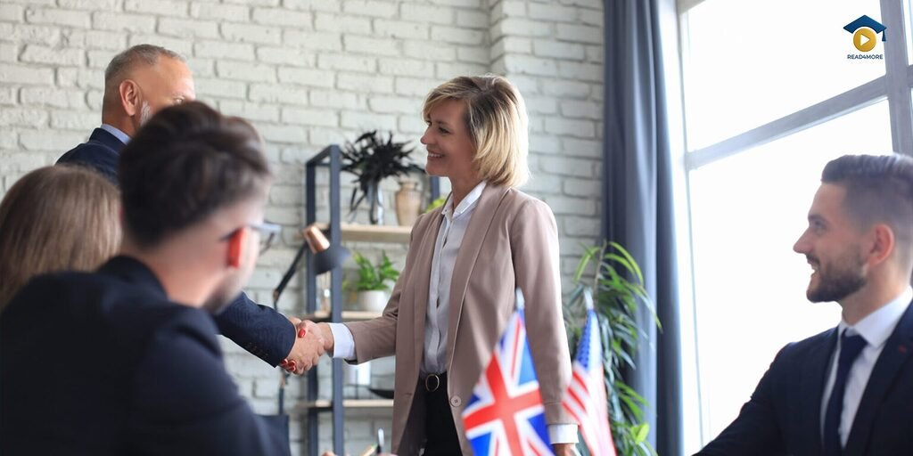 Professional business partners shake hands to finalize an international deal, with UK and US flags present, showcasing the negotiation skills taught in the Business English Course Pack from read4more.com.