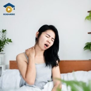 A young woman wakes up in bed and rubs her neck, which is in pain, visually representing joint stiffness. This image is a vocabulary aid from read4more.com for a medical English lesson on describing patient symptoms for the OET exam.