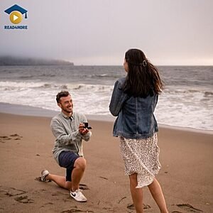 A man proposing to a woman on a beach, visually defining the English vocabulary word "engaged" (having agreed to marry someone) for the Read4More online glossary.