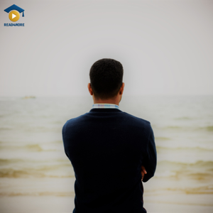 A man standing alone on a beach looking out at the ocean, visually defining the English vocabulary word "single" (not married or in a relationship) for the Read4More online glossary.