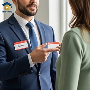 A man with a name tag handing a blank badge to a woman, visually defining the English possessive adjective "your" (belongs to you) for the Read4More online glossary.