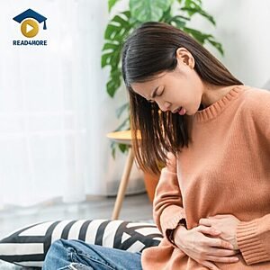 A woman clutching her stomach in apparent discomfort, visually defining the English verb "hurt" (to feel pain) for the Read4More online glossary.