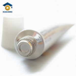 A close-up of an open metal tube of ointment with a white cap, visually defining the English vocabulary word for a soft skin medicine.